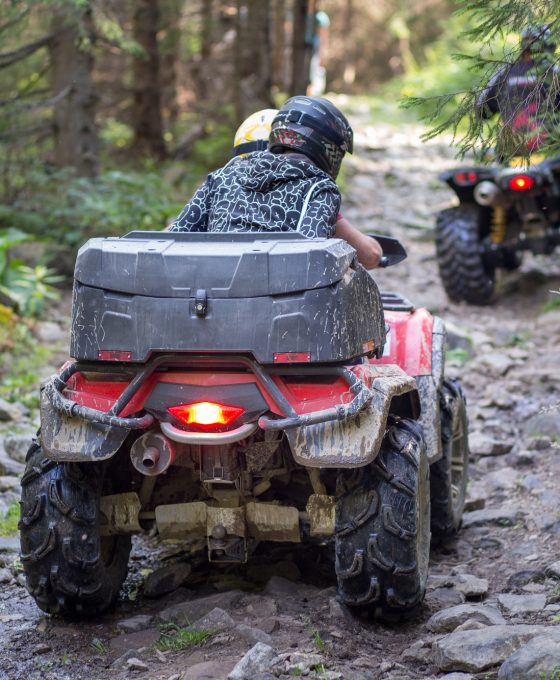 ATV on the mountain road in forest causing erosion problem for environment